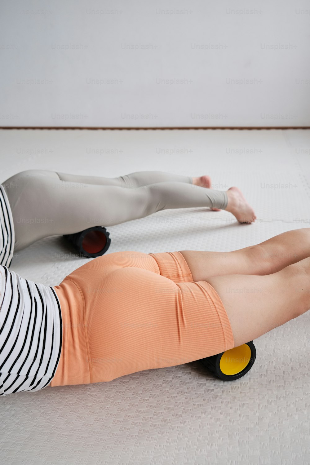 a woman laying on top of a mattress on top of a floor