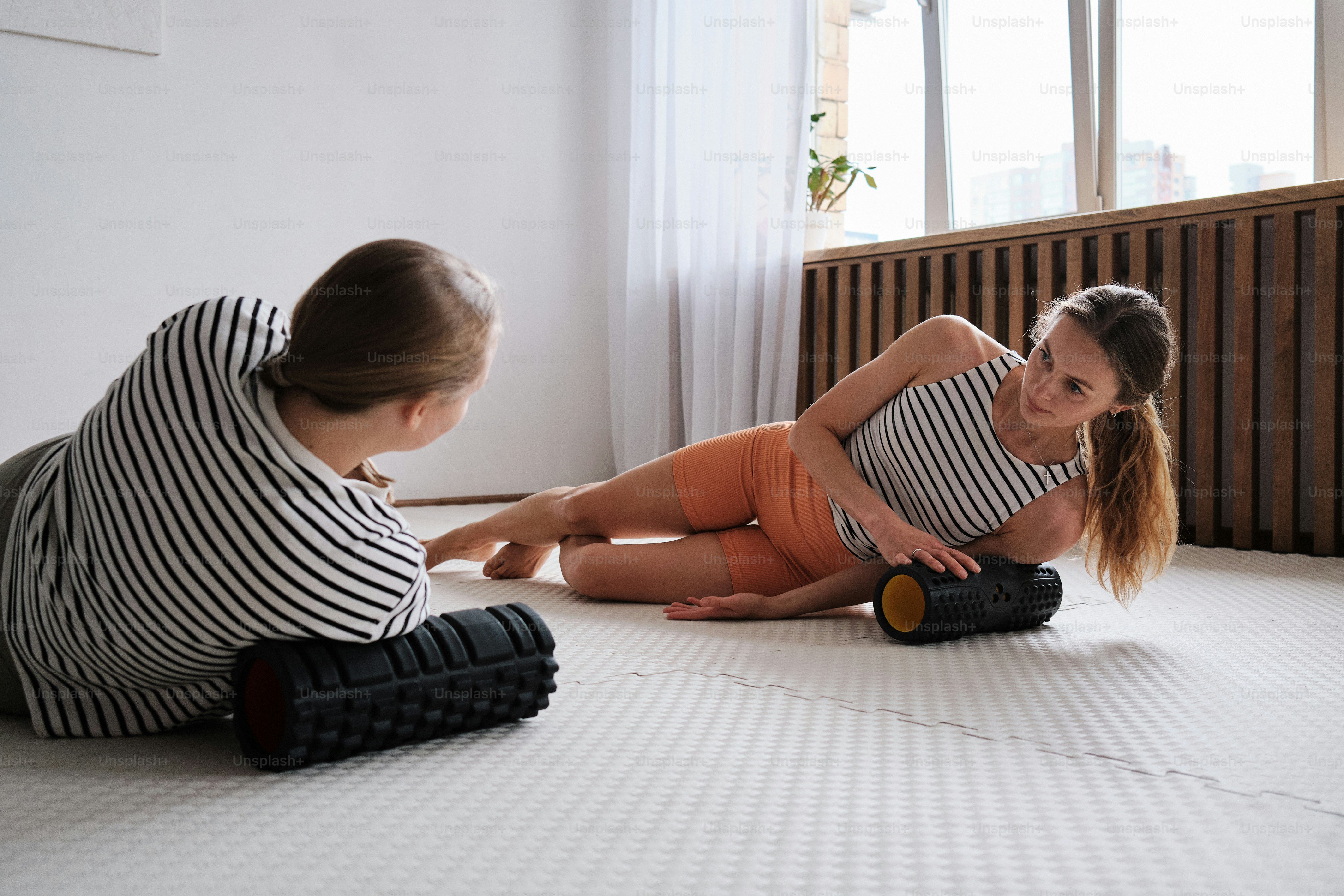 two women sitting on the floor playing with each other