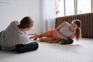 two women sitting on the floor playing with each other