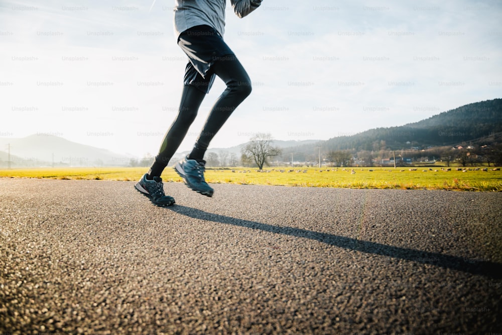 a person running on a road with a sky background