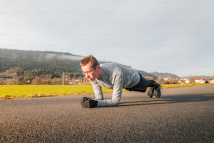 a man is doing push ups on the street