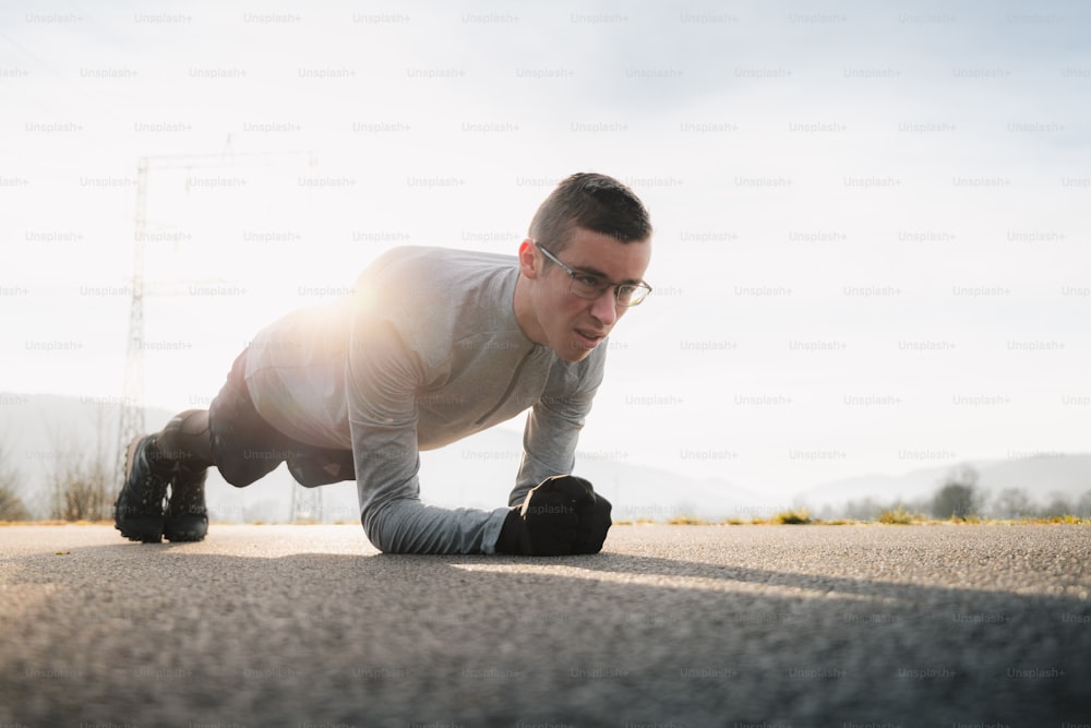 a man is doing push ups on the street