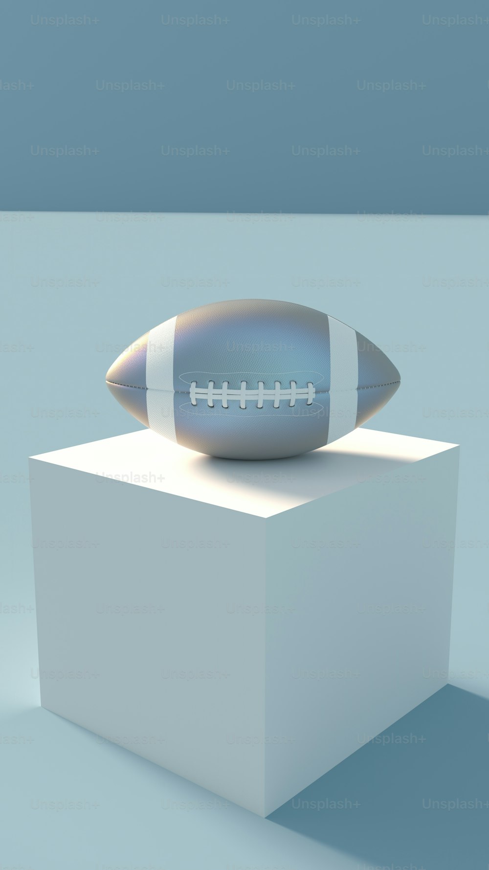 a football sitting on top of a white pedestal