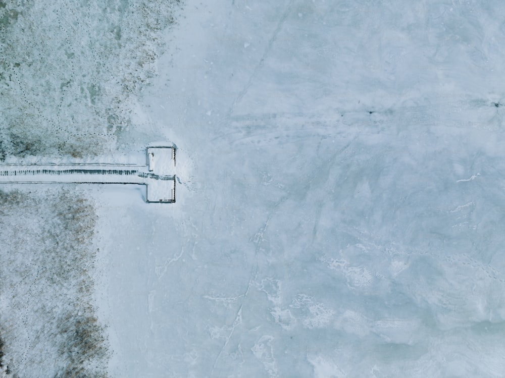 an aerial view of a road in the snow