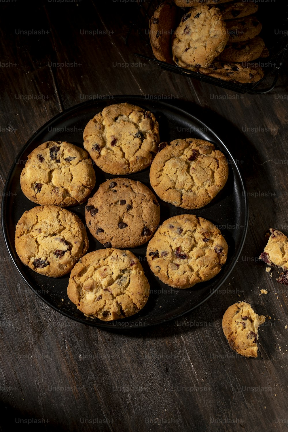 a plate of chocolate chip cookies on a wooden table