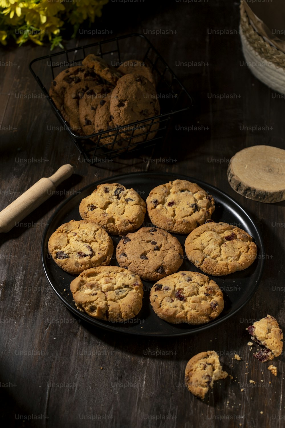 a plate of chocolate chip cookies on a wooden table