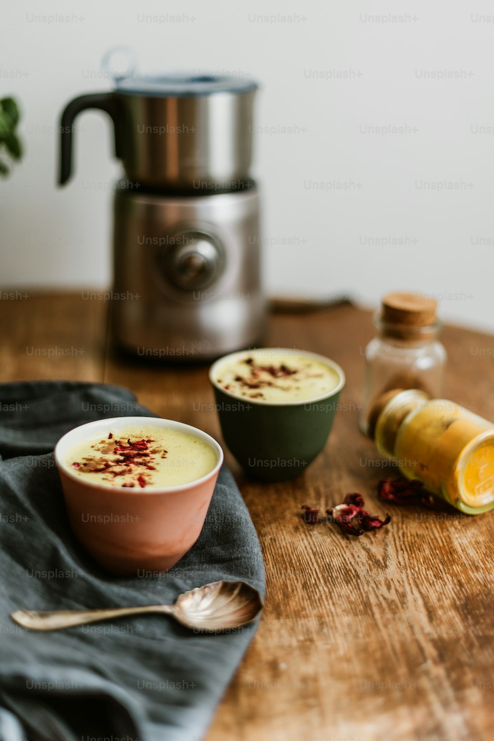 a wooden table topped with two bowls of food