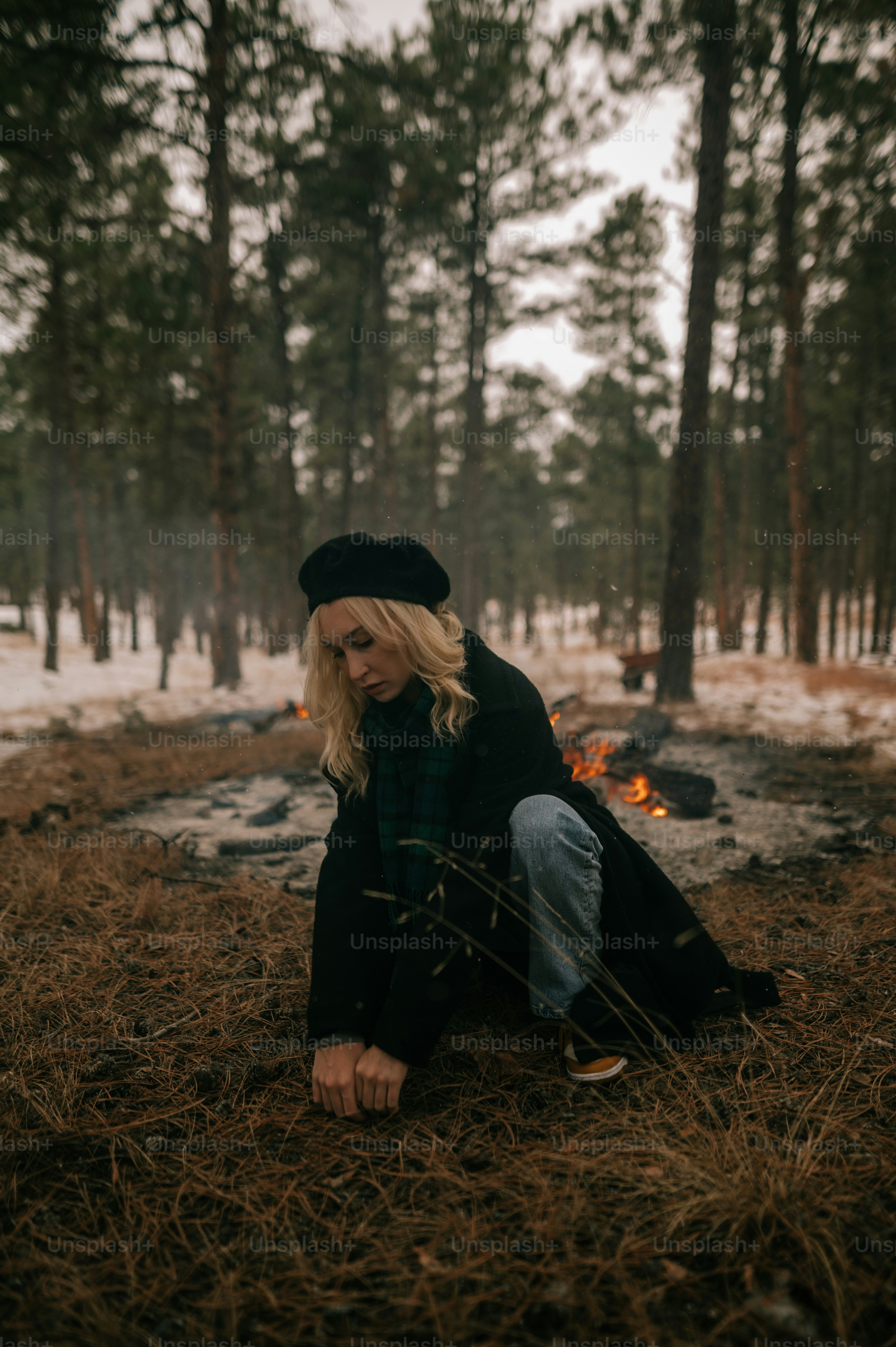 A woman sitting on the ground in the woods photo – Face Image on Unsplash