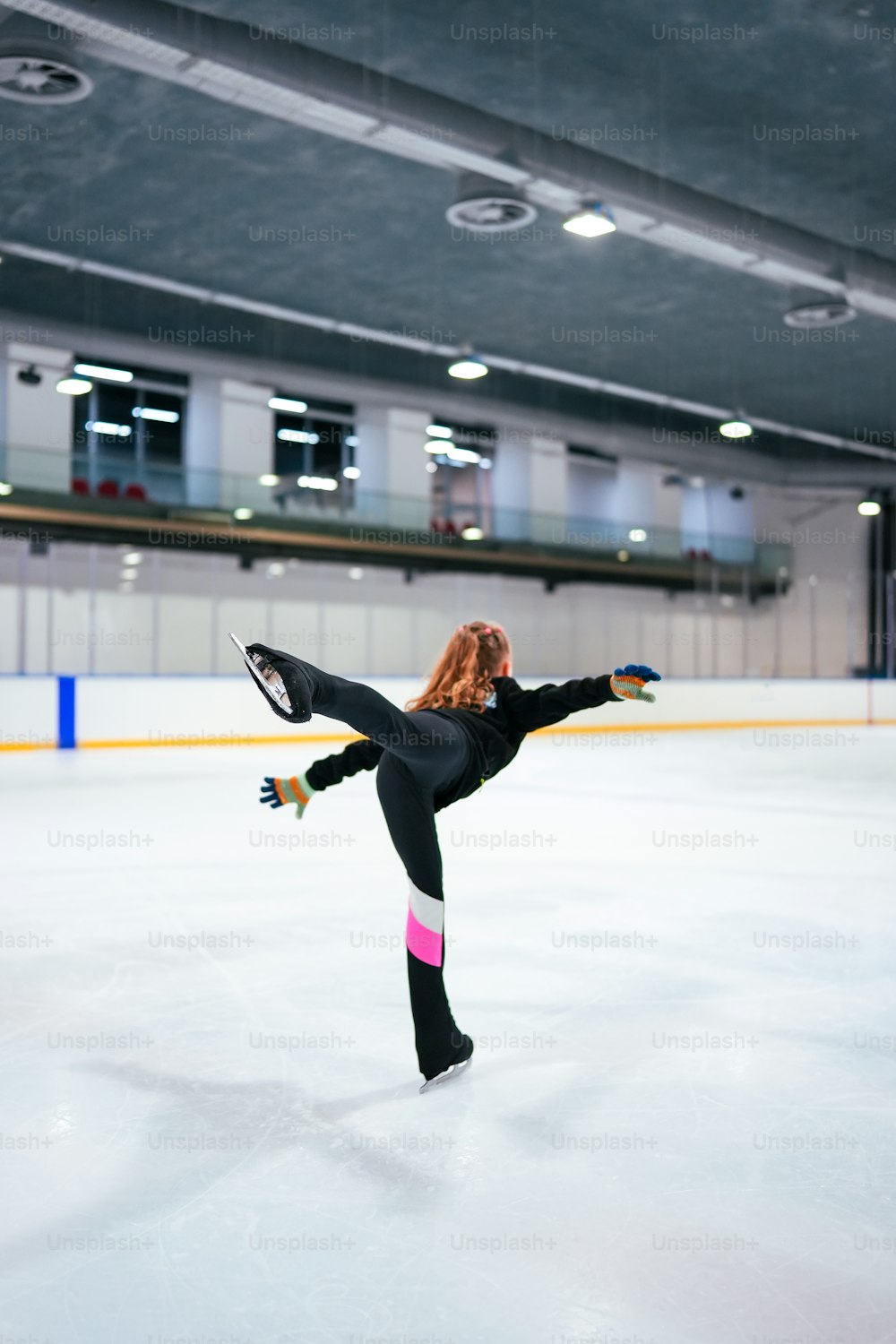 a woman is skating on an ice rink