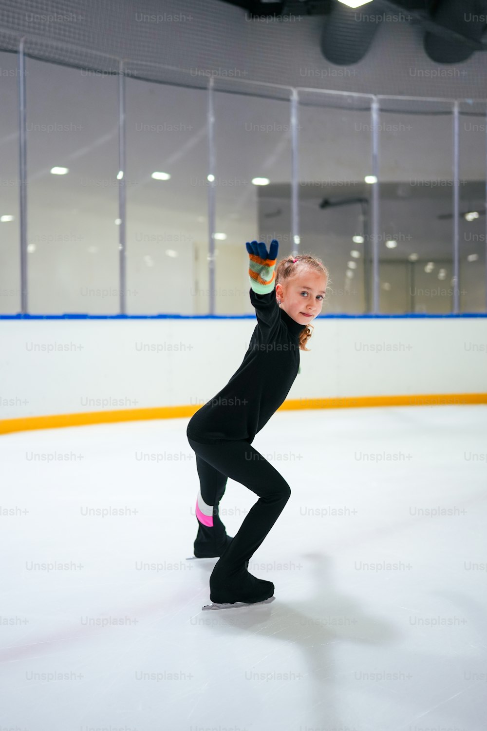 a woman is skating on an ice rink