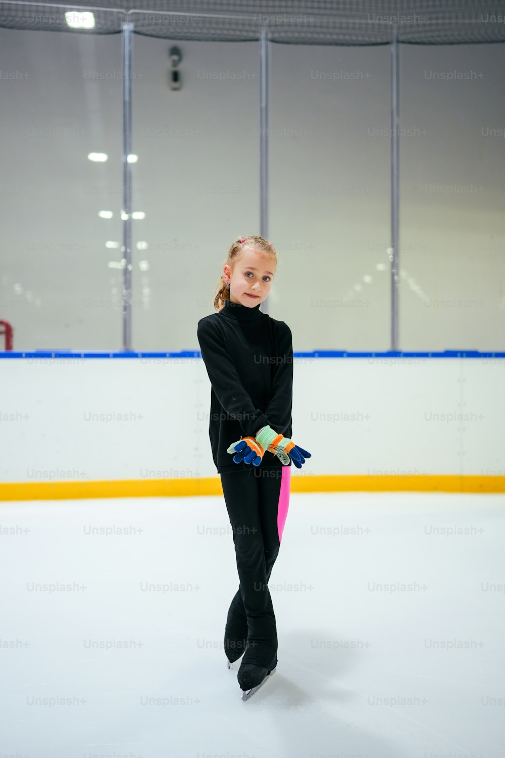 a young girl skating on an ice rink