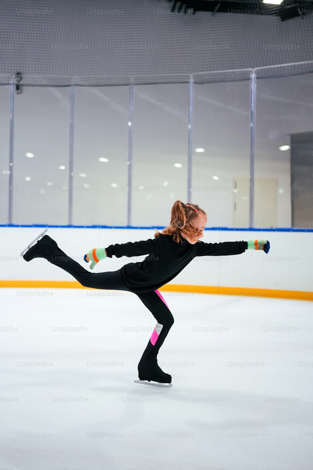 a woman is skating on an ice rink