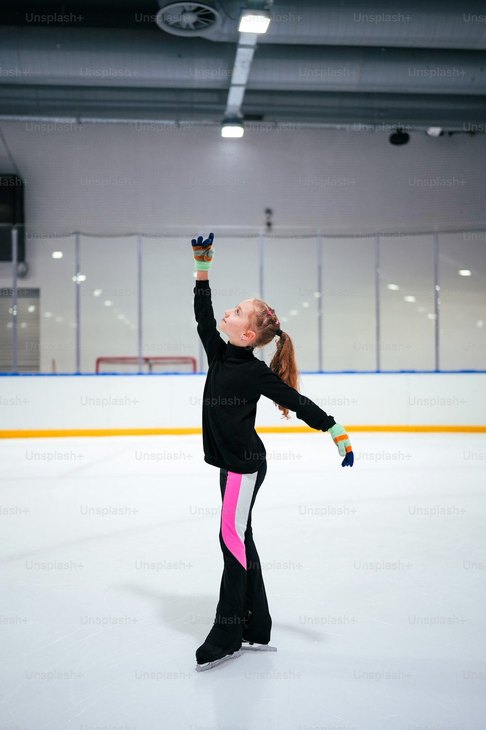 a young girl skating on an ice rink