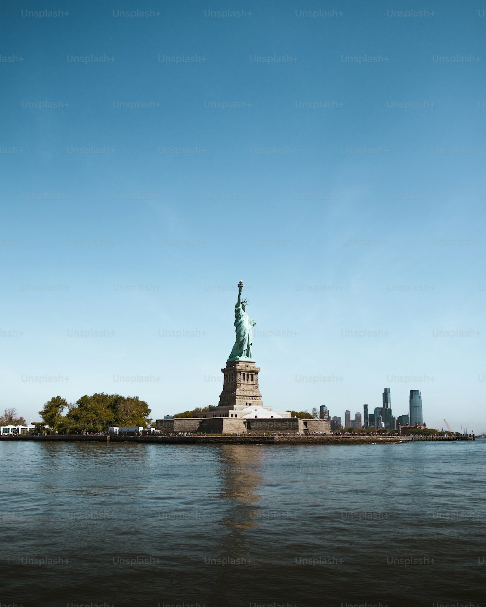 a view of the statue of liberty from across the water