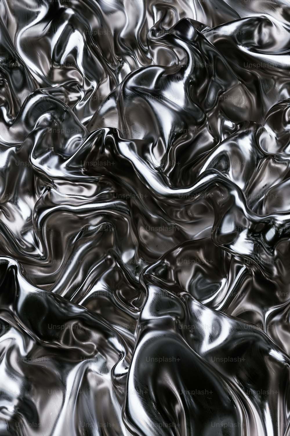 a black and white photo of a bunch of shiny material