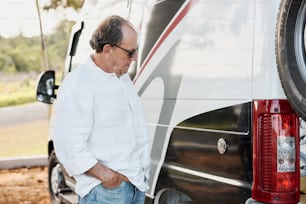 a man standing next to a white van