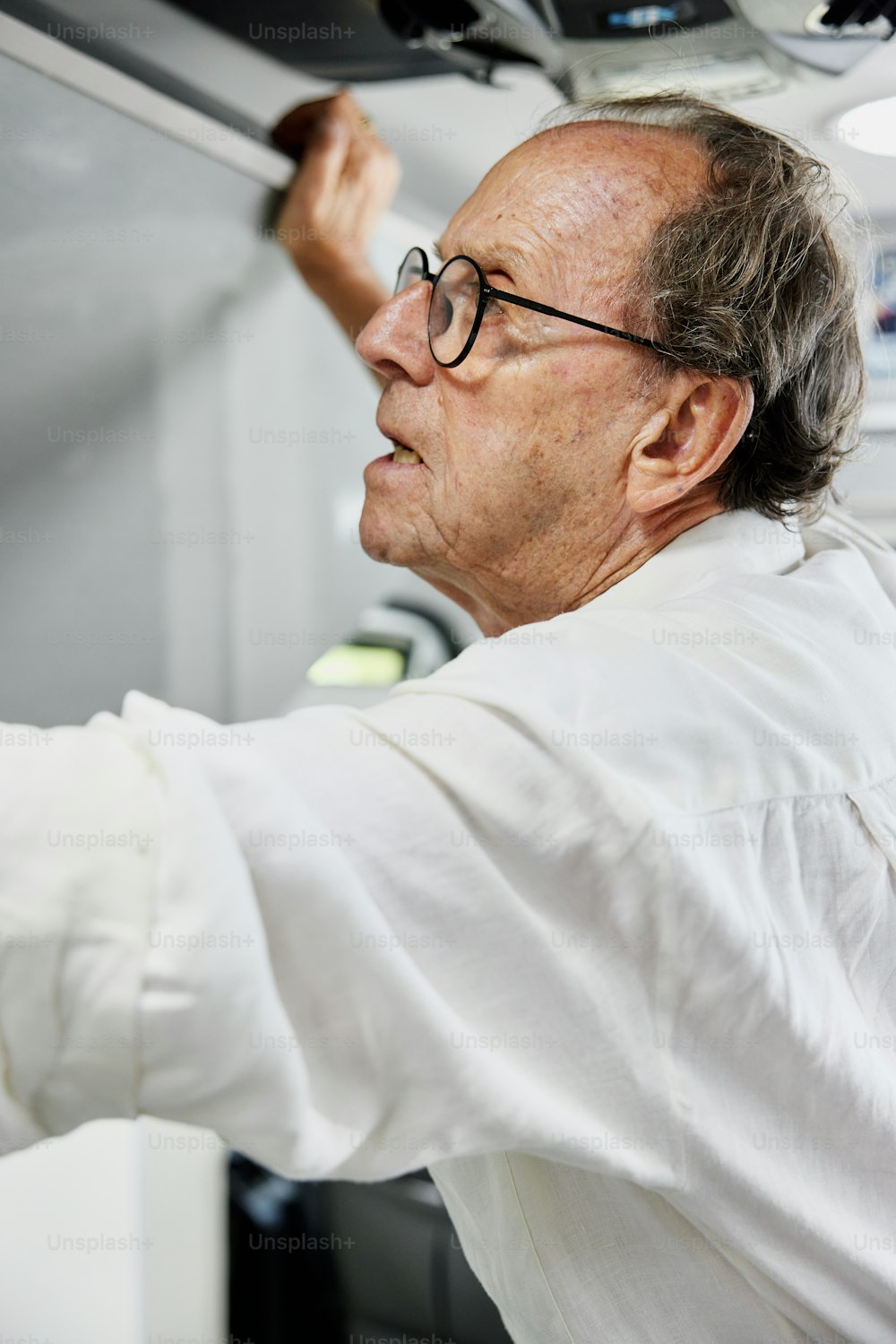 a man in a white lab coat and glasses