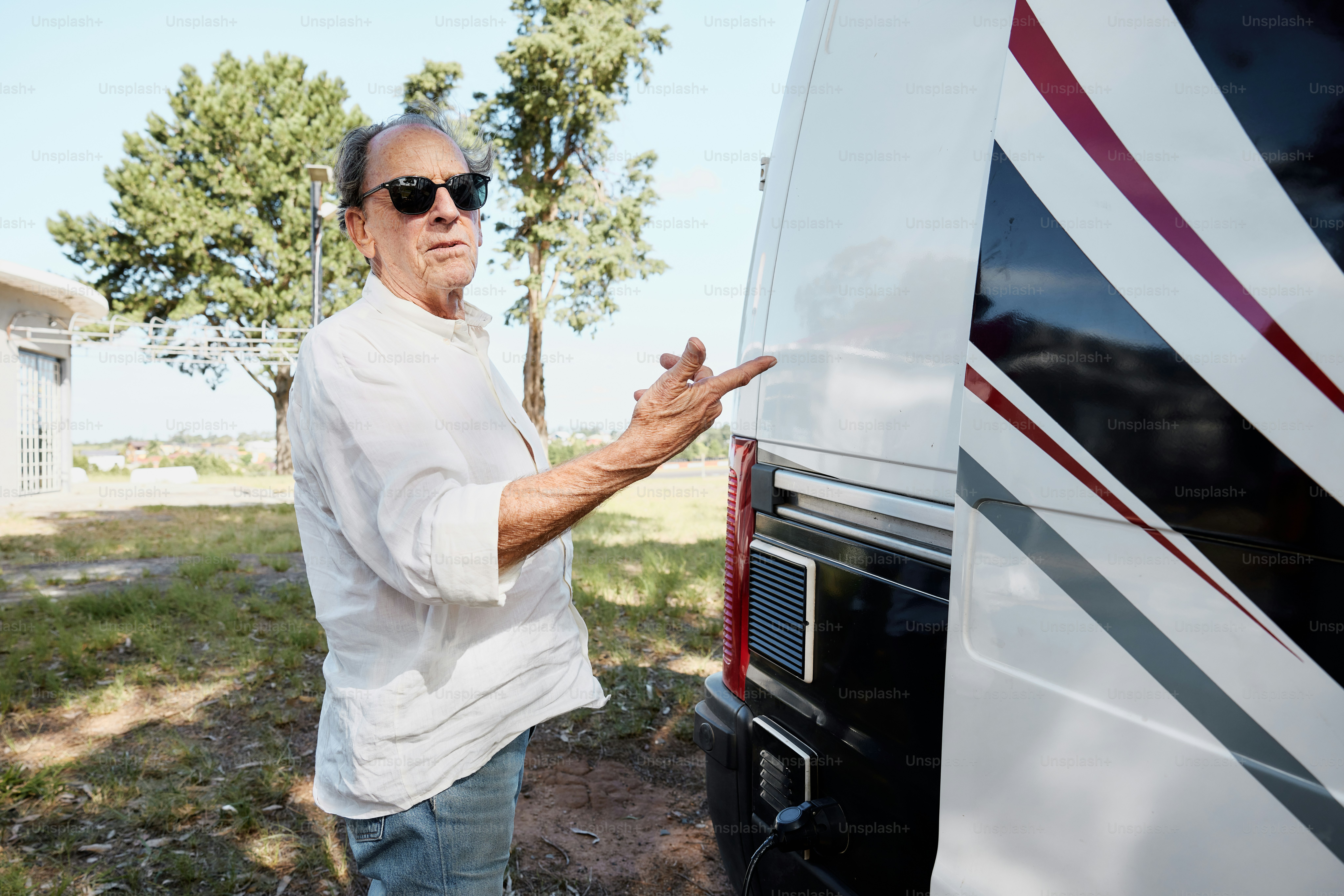 a man standing next to a white truck