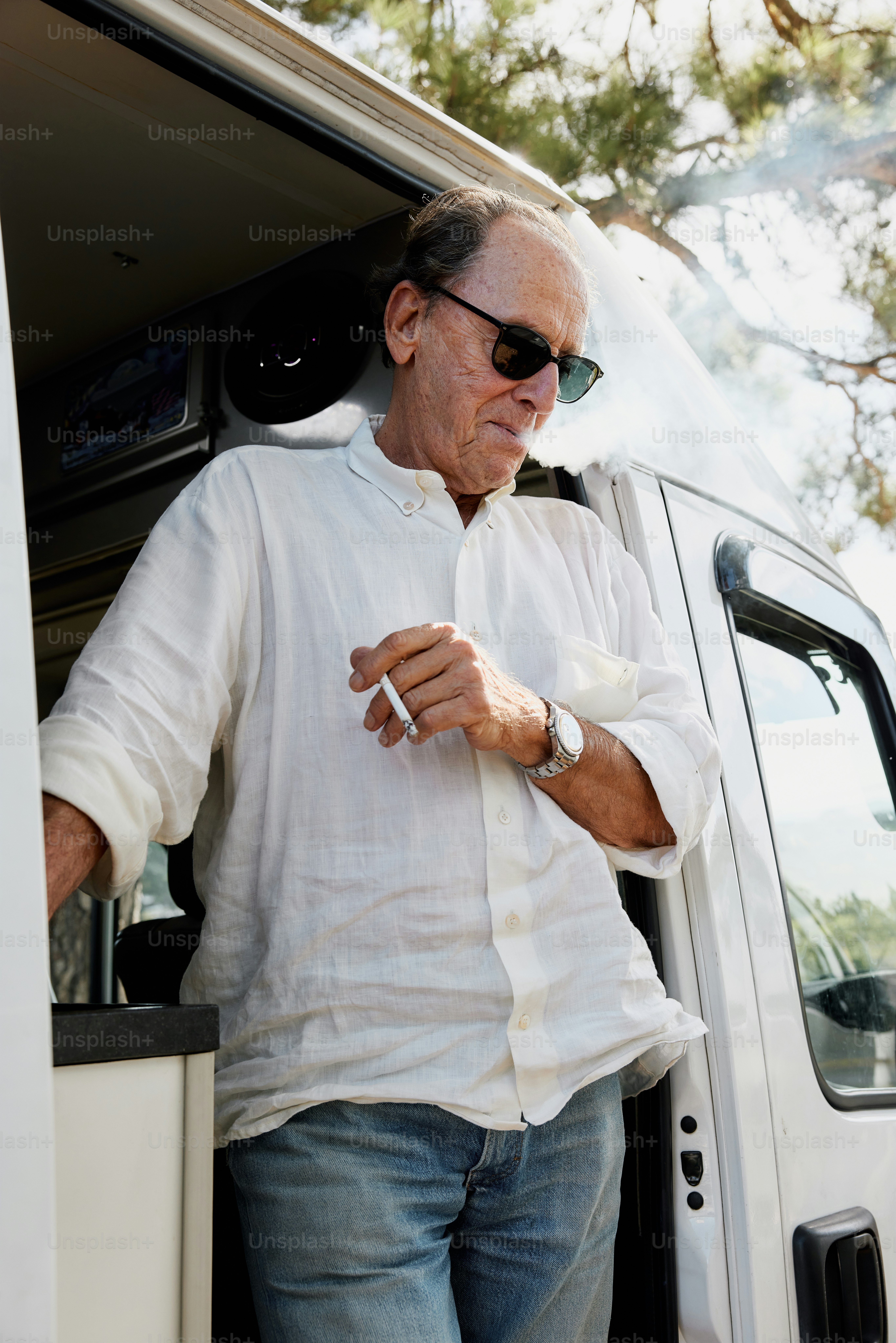 a man standing in the open door of a van