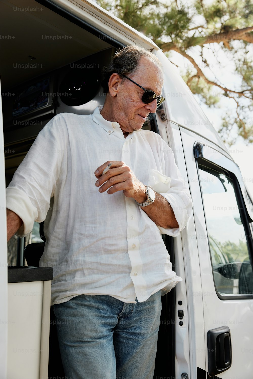 a man standing in the doorway of a white truck