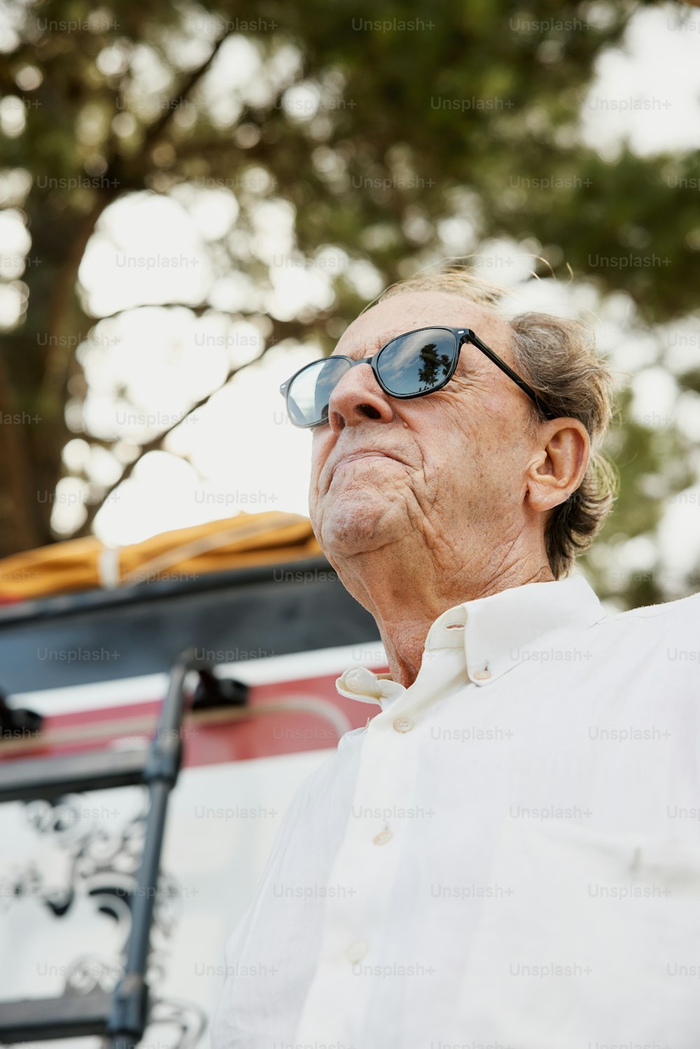 a man wearing sunglasses and a white shirt