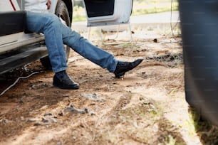 a man sitting in the back of a white truck