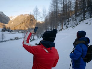 a couple of people standing in the snow