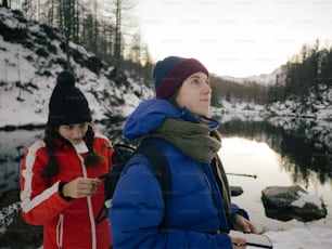 a couple of women standing next to each other in the snow