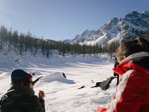 a couple of people that are standing in the snow