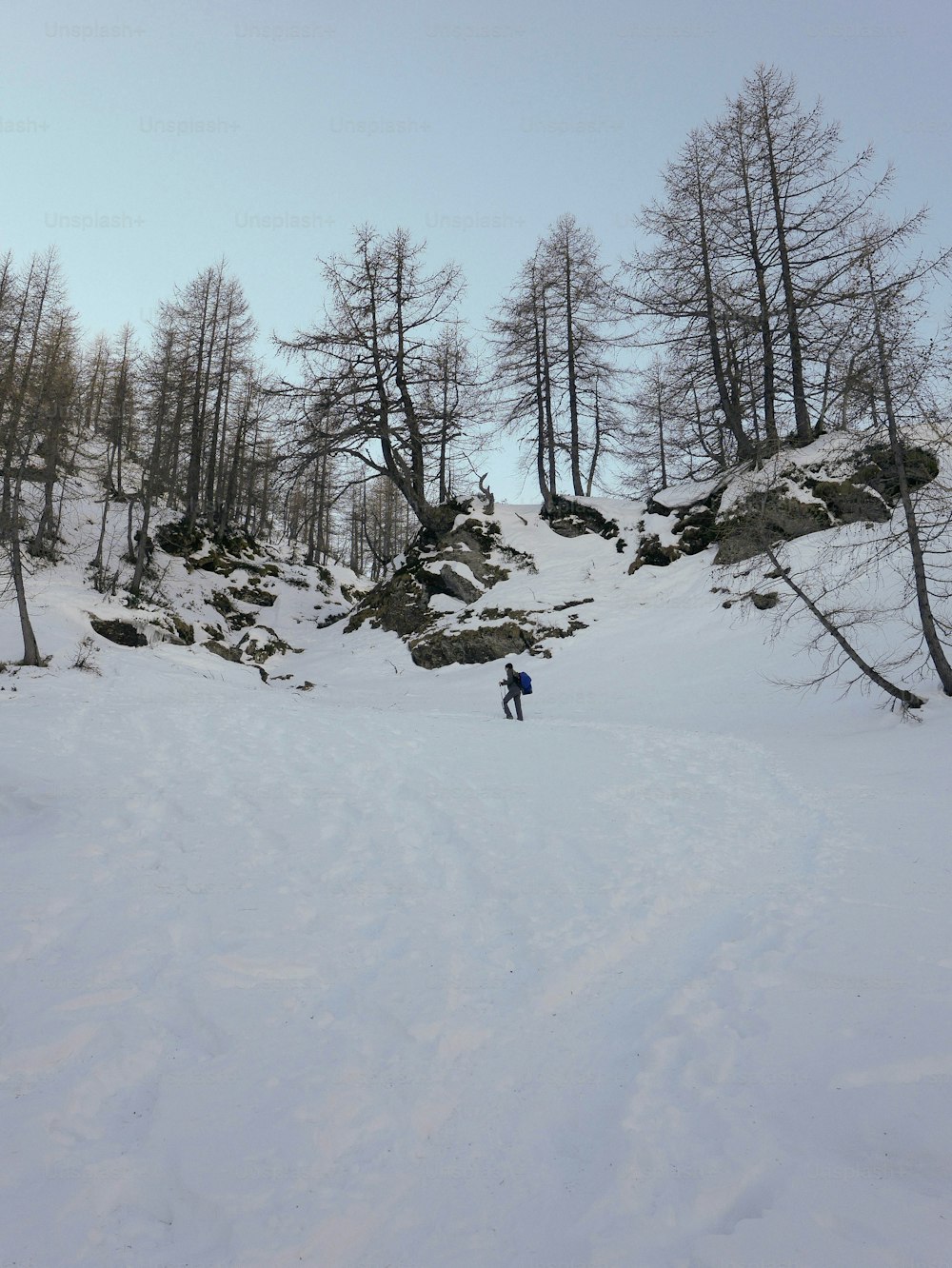 a man riding skis down a snow covered slope