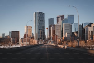 a city street with tall buildings in the background