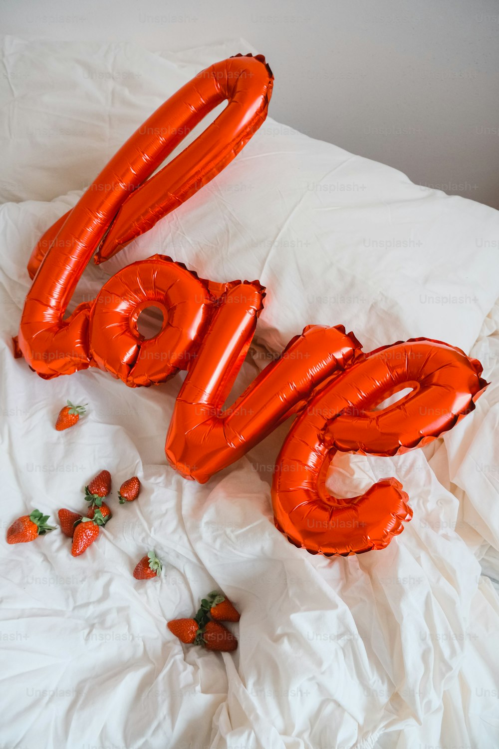 a couple of balloons that are on a bed