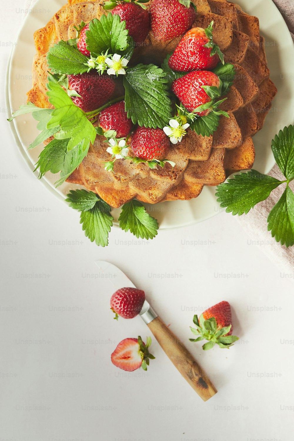 a plate of waffles topped with strawberries and flowers