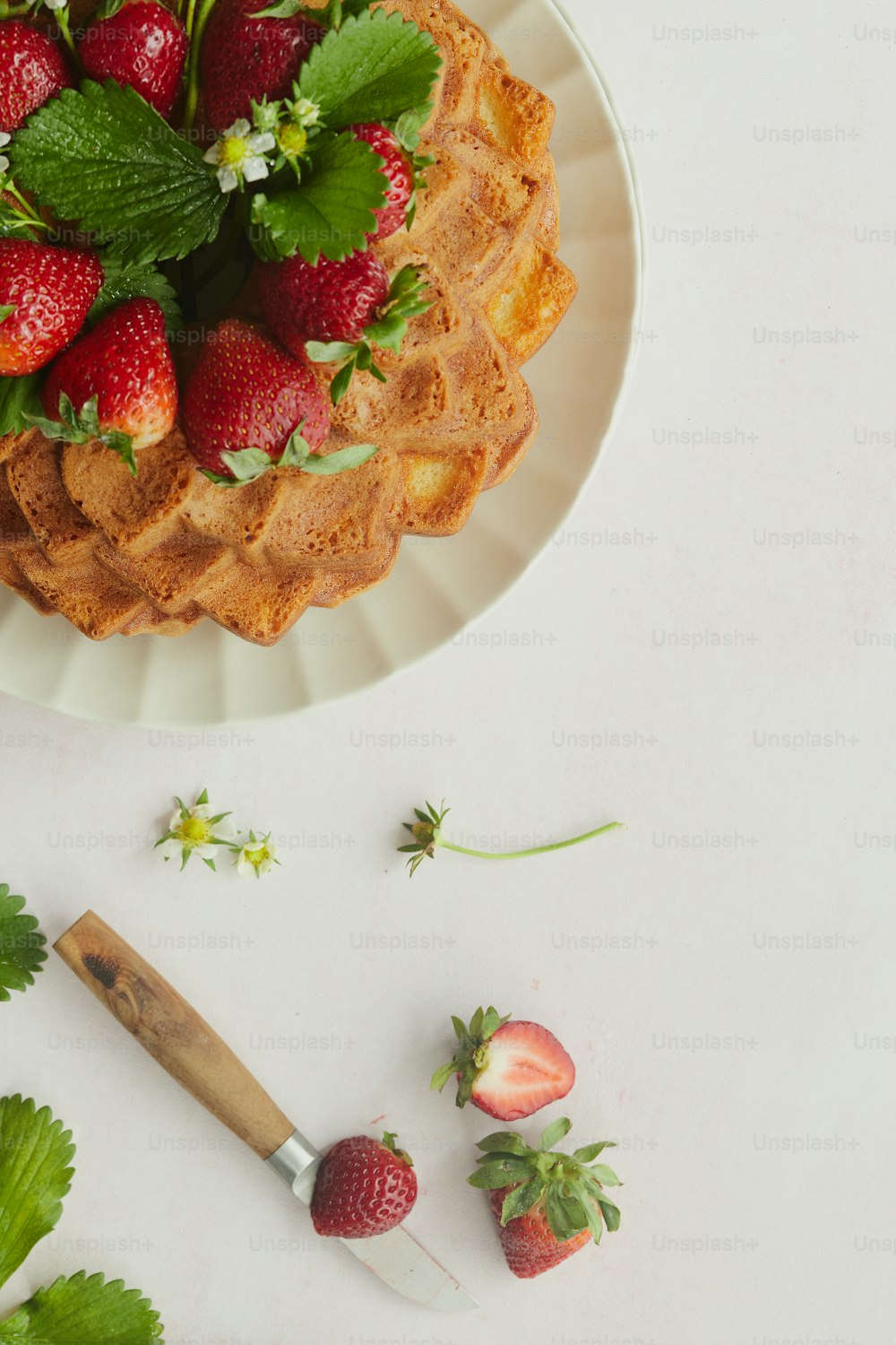 a plate of waffles with strawberries on top