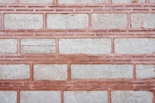 una pared de ladrillo rojo con un patrón de ladrillo blanco