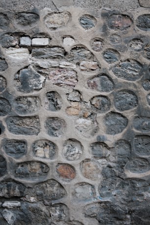 a close up of a stone wall with holes in it
