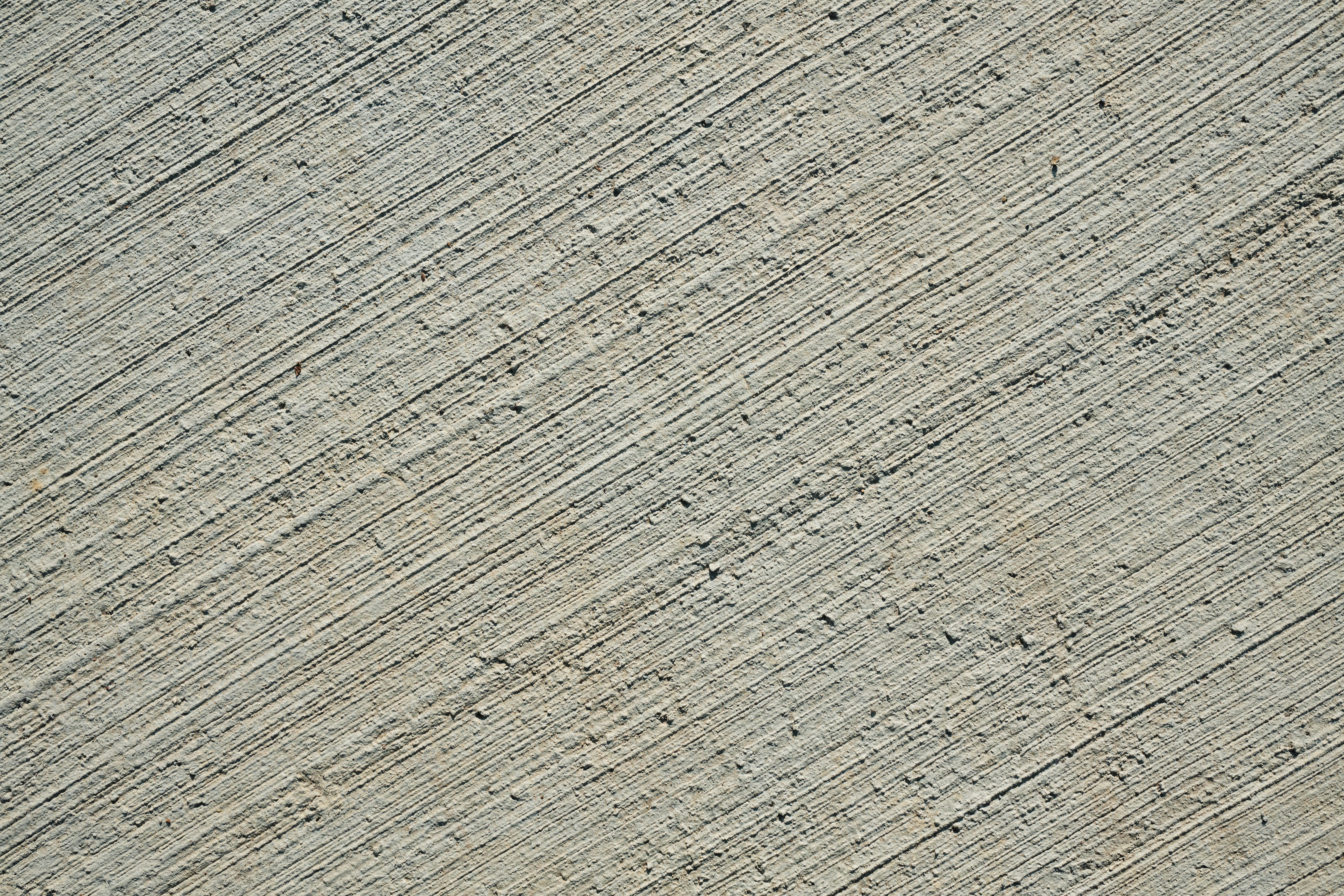 a man riding a skateboard on top of a sidewalk