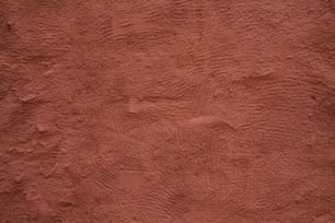 Gros plan d’un mur de stuc rouge