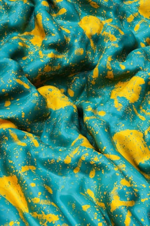 a blue and yellow cloth with yellow spots