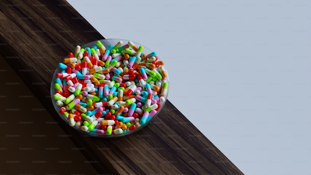a plate of sprinkles on a wooden surface