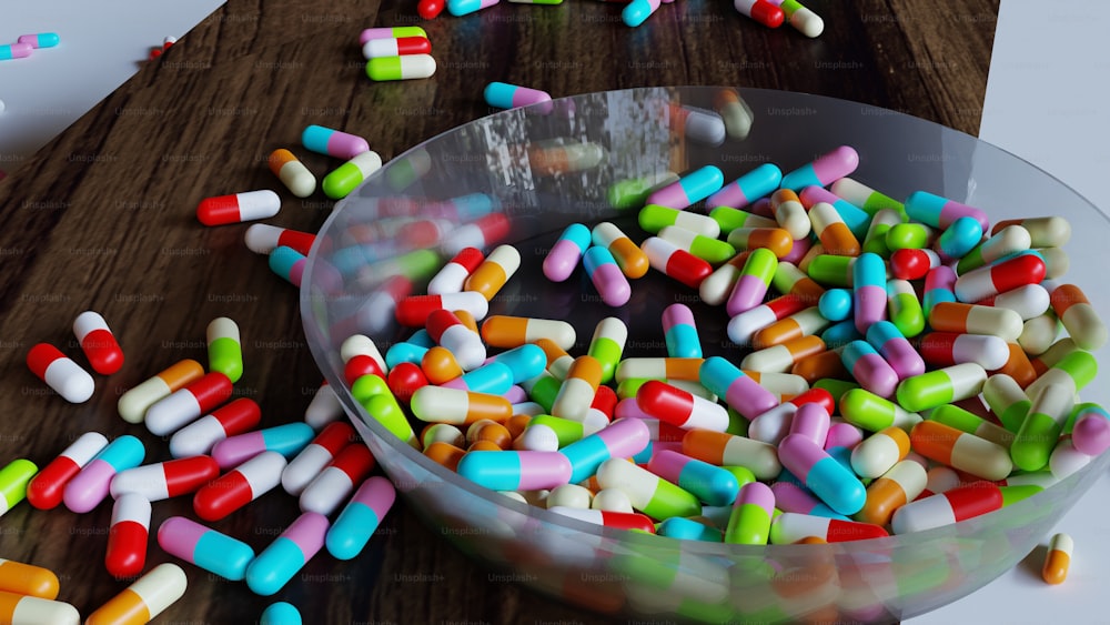 a bowl full of colorful pills on a table