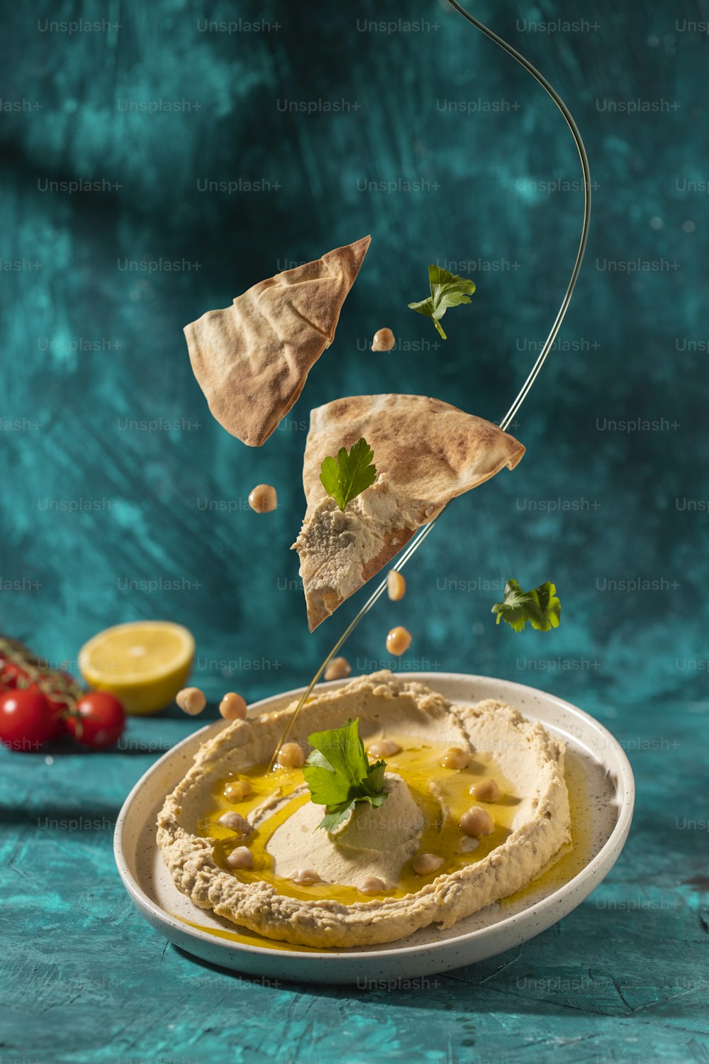 a plate of hummus with a garnish on top of it