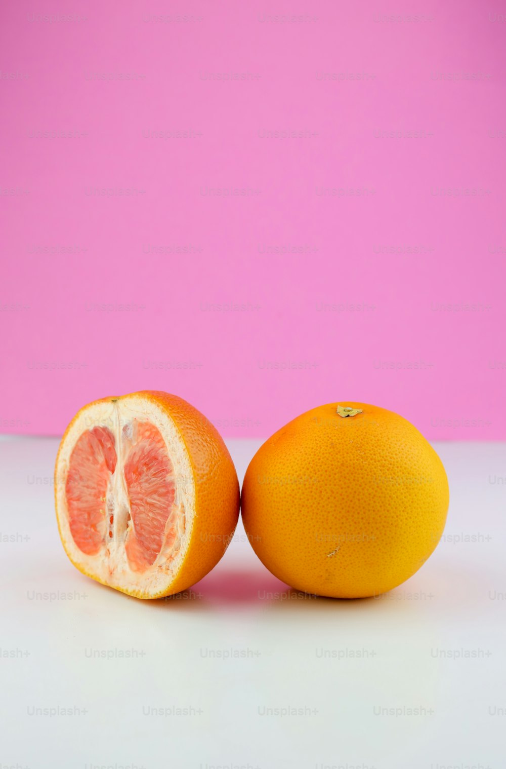 two oranges cut in half sitting on a table