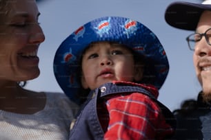 a little boy wearing a blue cowboy hat