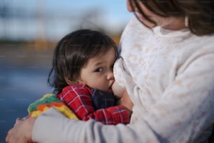 a woman holding a small child in her arms