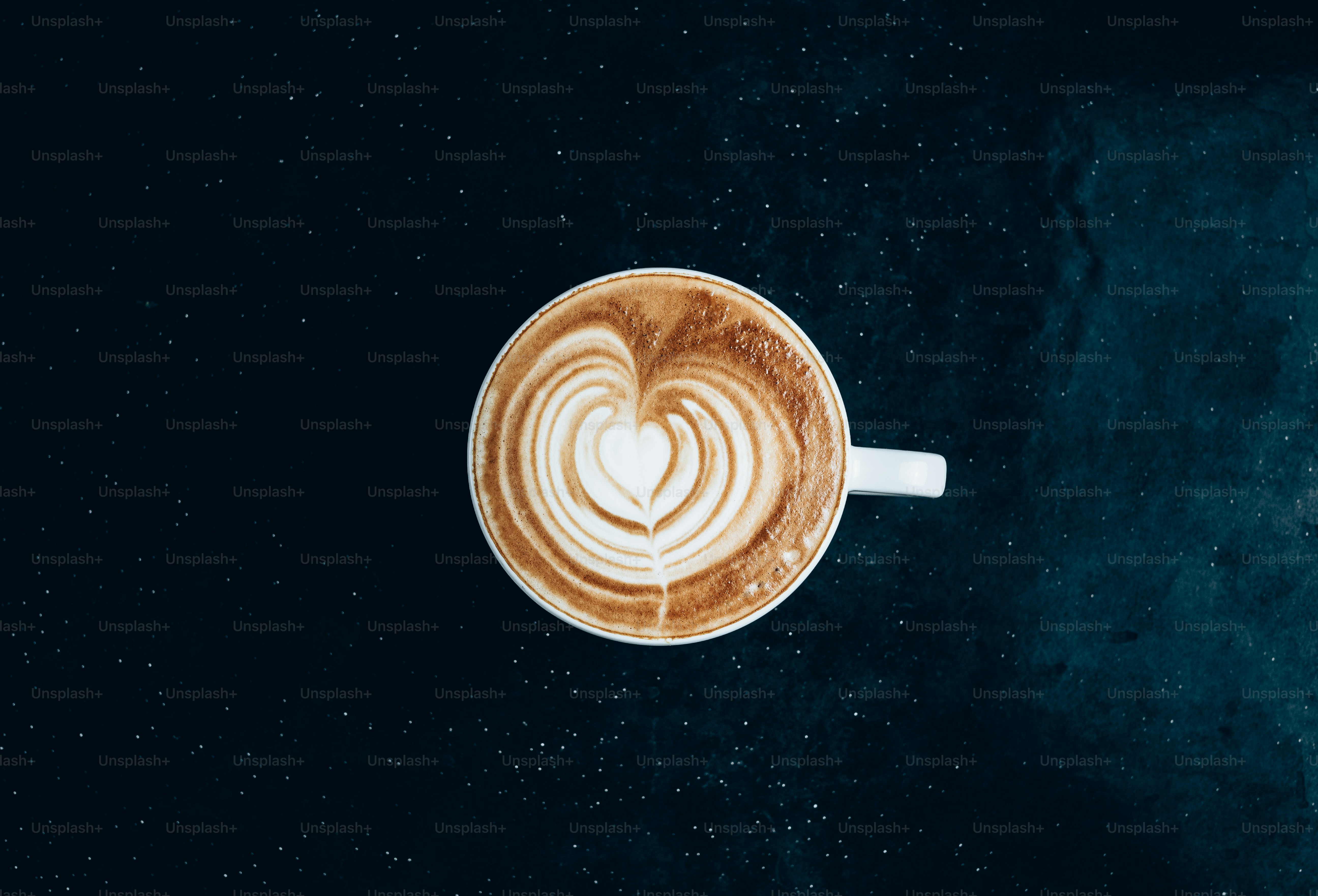 a cappuccino with a heart in the foam