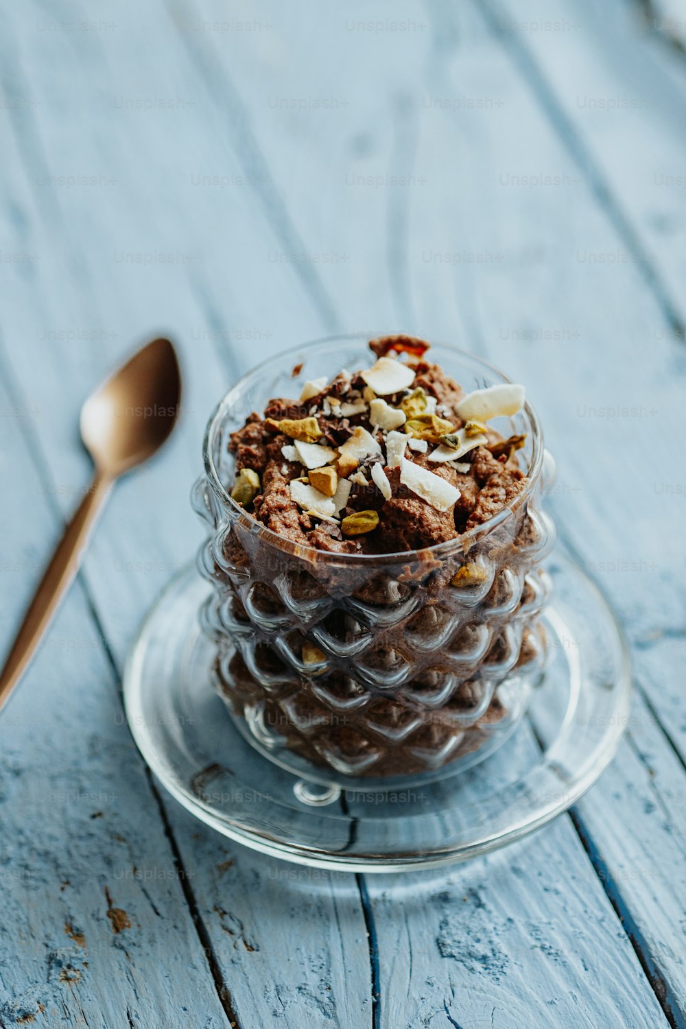 a glass bowl filled with food on top of a wooden table