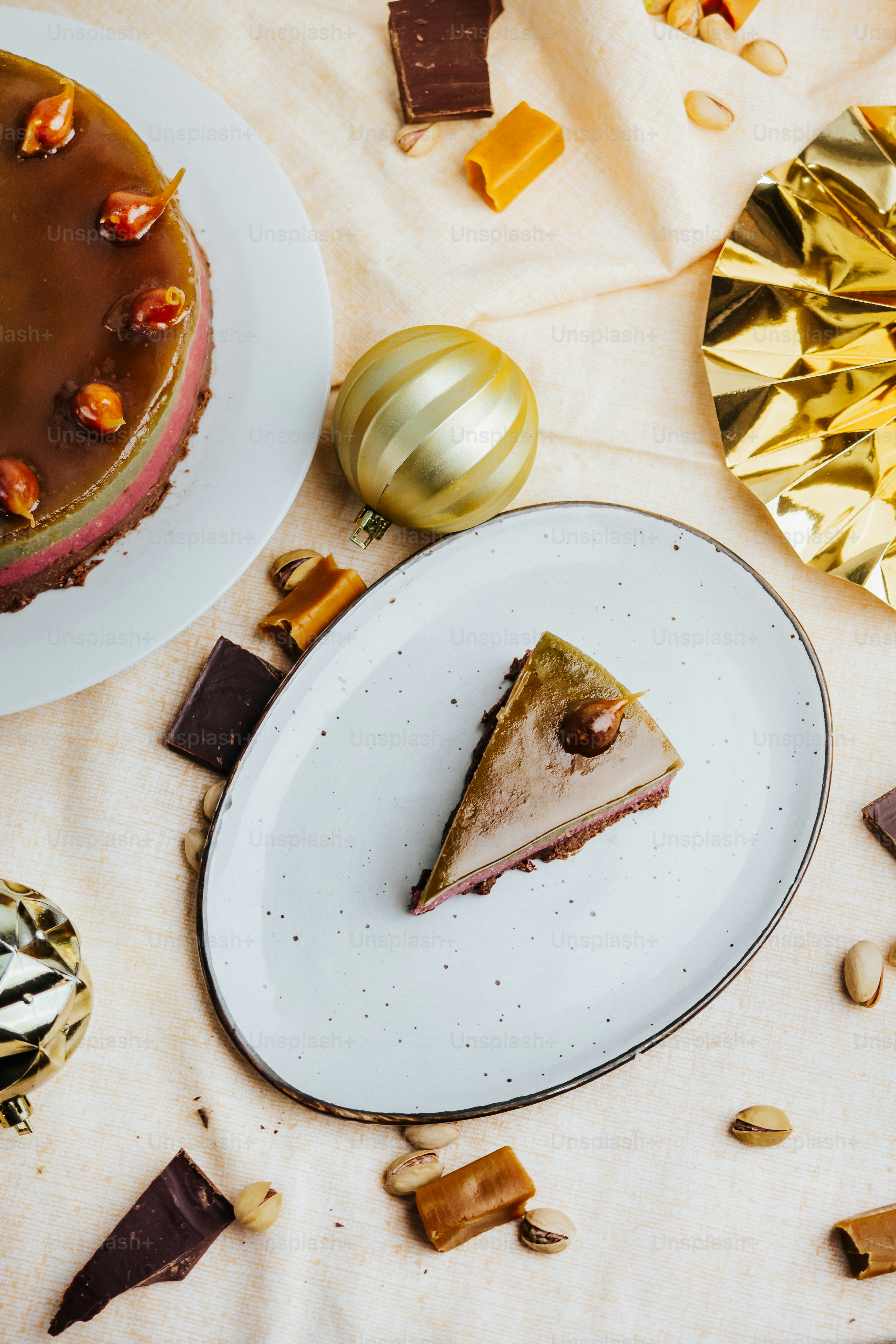a piece of cake on a plate next to a plate with a piece of cake