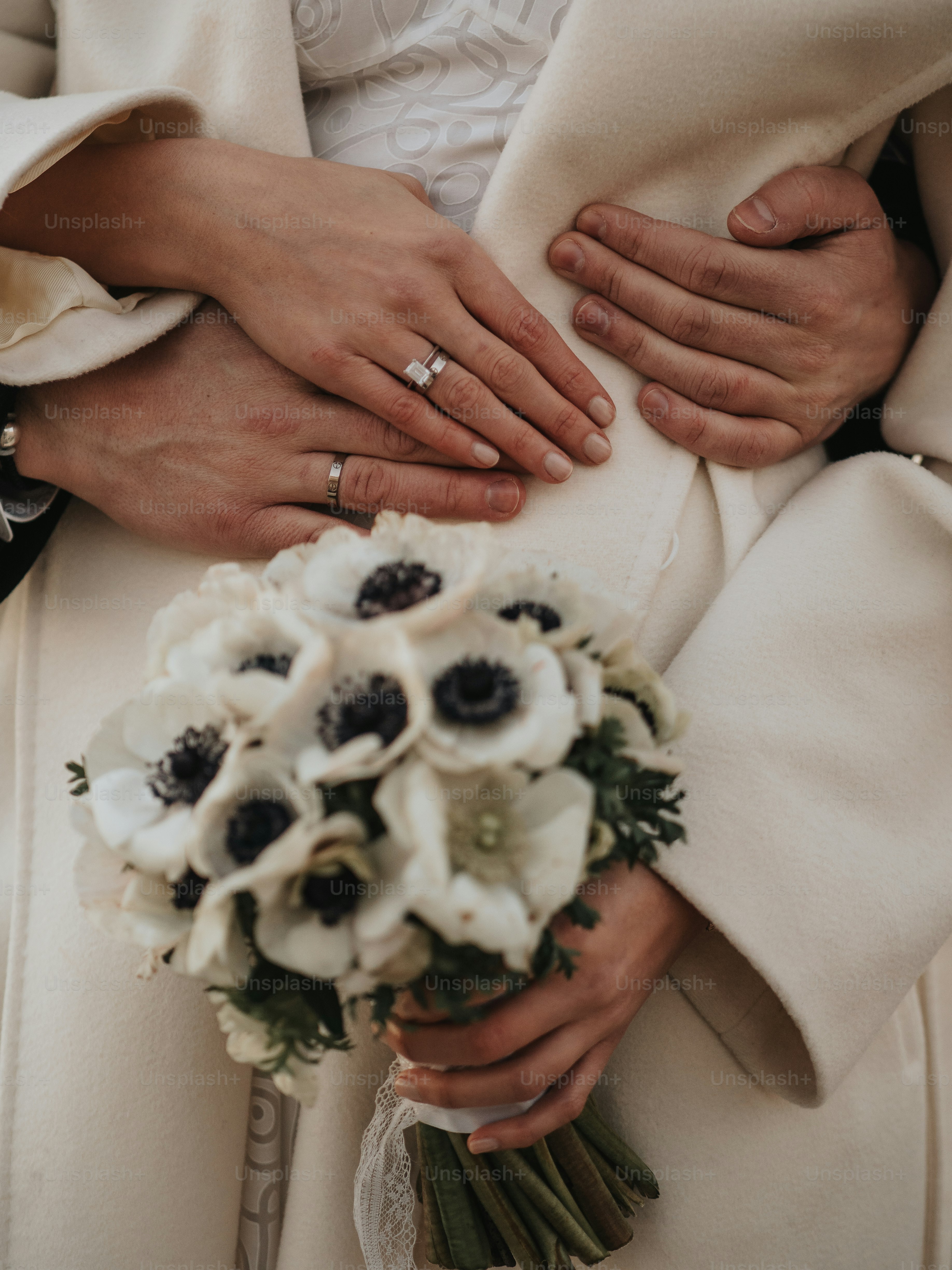 a close up of a person holding a bouquet of flowers