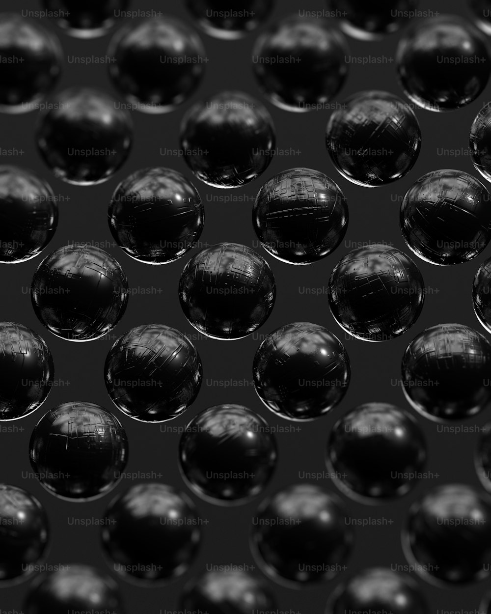 a lot of shiny black balls on a black background